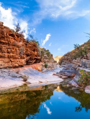 Serene waters and red cliffs of Paradise Valley, Morocco