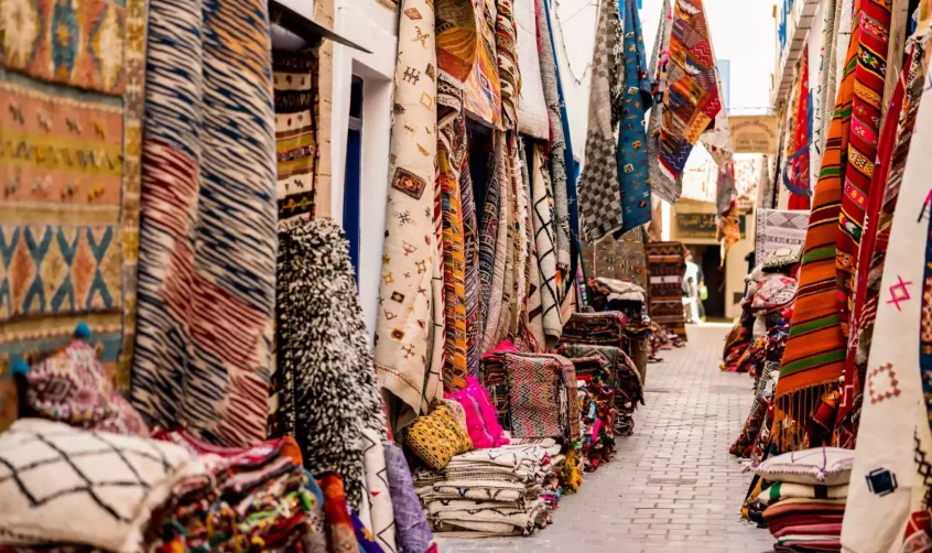 Street in Morocco with stores selling Morocco rugs.