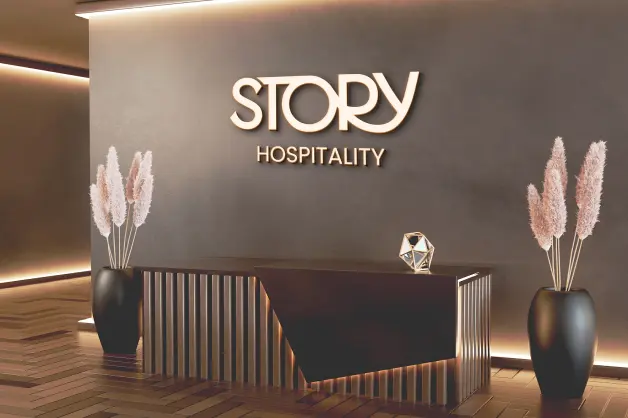 A sleek and modern reception area at STORY Hospitality, featuring stylish design elements and the brand's logo. As part of the finest Morocco hotels, 5-star luxury is at the heart of the STORY experience.