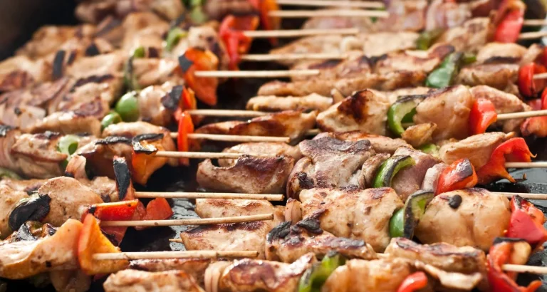 Grilled Moroccan chicken brochettes with peppers on skewers, a popular street food found in markets and food stalls.