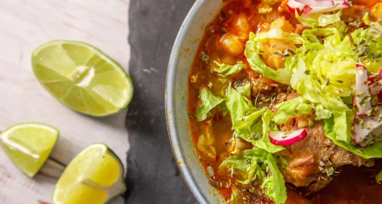 Traditional Moroccan harira soup served with fresh lime, vegetables, and herbs, a popular street food and Ramadan dish.