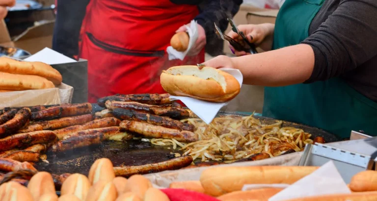 Grilled sausages with bread and onions served at a Moroccan street food market.