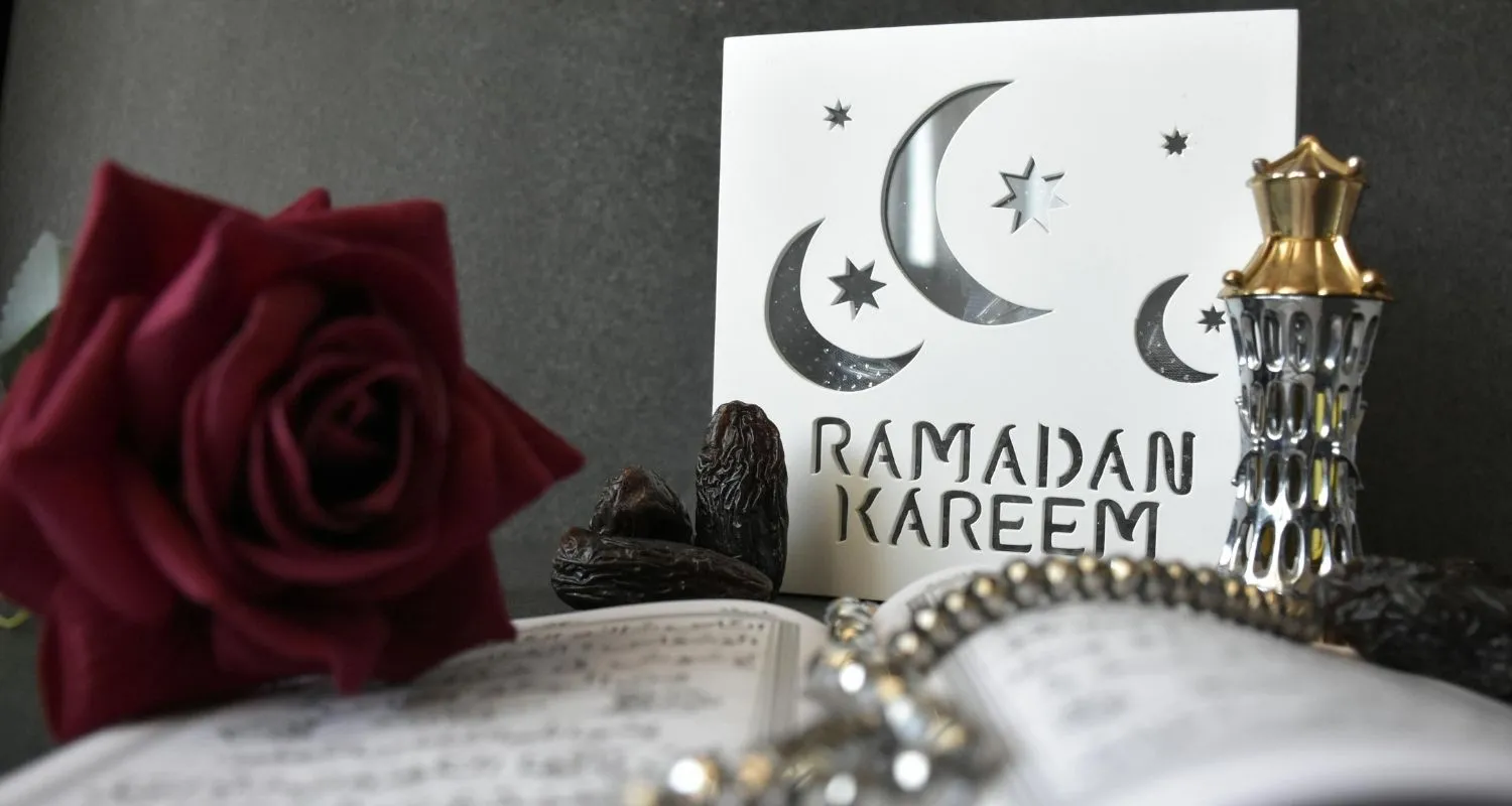 Ramadan Kareem greeting with Quran, dates, and traditional decor